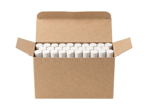 Many chalk sticks arranged in a cardboard box with open flaps during bright studio lighting isolated on transparent background