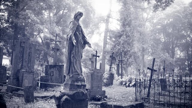 Virgin Mary statue at Bernardine Cemetery in Vilnius, Lithuania &ndash; cinematic camera movement, black and white