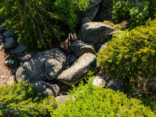 Aerial view of Granodiorite rock formation with visible signs of weathering and erosion known as Markov kamen. Markov Kamen famous rock in between the trees on the Kopaonik mountain in Serbia © nedomacki