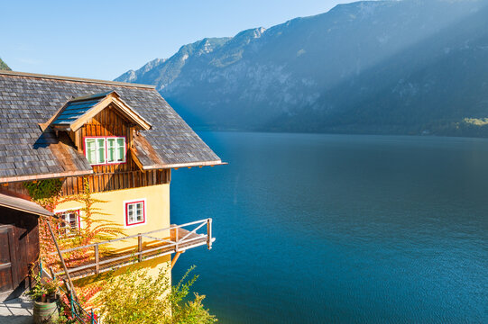 Colorful architecture on the shore of lake in Hallstatt village, Austria. Alps mountains in the background. Beautiful autumn landscape at sunny day