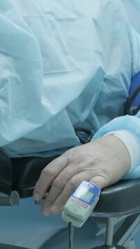 Professional ophthalmologist performing cataract removal and intraocular lens (IOL) implantation under a surgical microscope in an operating room.