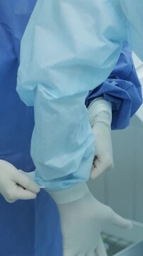 Professional ophthalmologist performing cataract removal and intraocular lens (IOL) implantation under a surgical microscope in an operating room.
