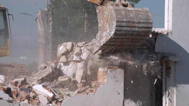 A crane demolishing a multi-story building in sunny weather.