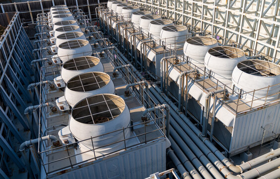 View of industrial cooling towers with large circular fans and metal piping systems in a grid framework in Busan, Busan, South Korea.