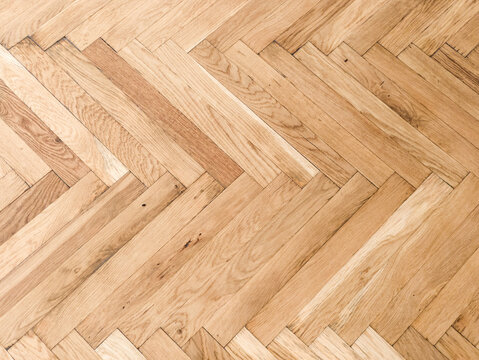 High angle background texture of wooden herringbone parquet flooring