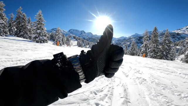Skier wearing luxury wristwatch on sunny mountain slope