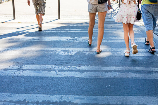 pedestrians crossing a zebra crossing in the city