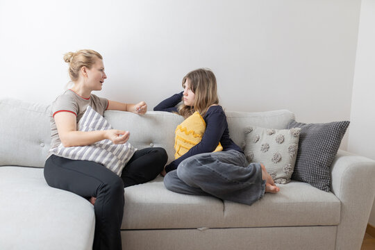 Mother and daughter having serious discussion on sofa