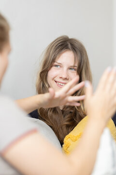 Young woman smiling interacting with person out of frame