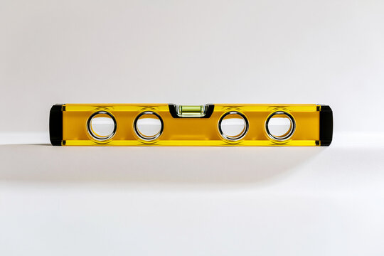 Yellow spirit level tool on white background