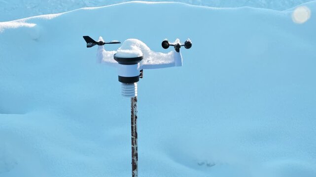 Wireless weather station on pole in snow. Sensors of temperature and humidity, Rain gauge and snow, Wind speed and direction. Climate monitoring, atmospheric research, Meteorological equipment. 4K.