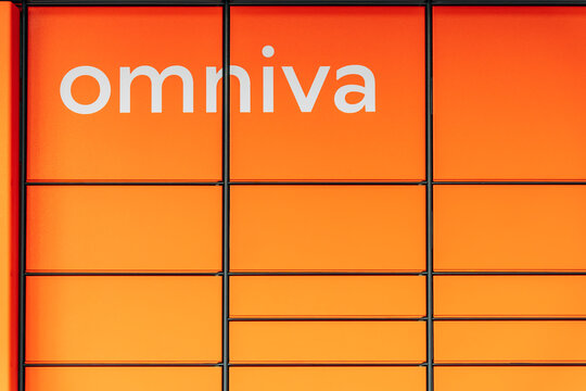 VILNIUS, LITHUANIA - APRIL 2025: Close-up of orange Omniva parcel locker compartments