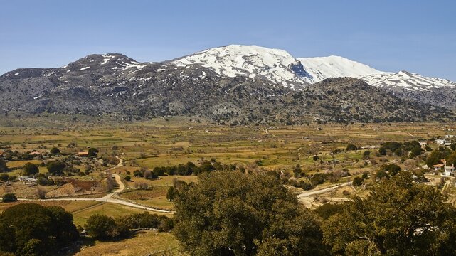 Katharo plateau, fields, trees, snow-capped mountains, Lassithi, East Crete, island of Crete, Greece