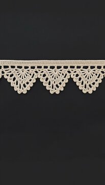 Decorative cream lace trim on a dark background  