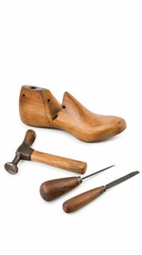 Wooden shoe last and cobbler tools on a white background  