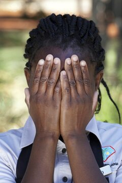 Namibian woman of the Ovambo tribe holding hands in front of her face, portrait, Namibia