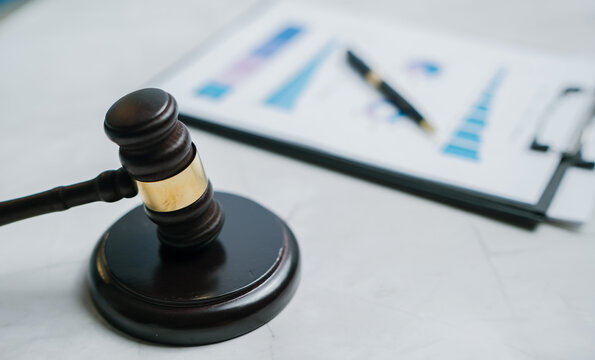 Wooden gavel financial chart ink pen legal document business analysis courtroom justice professional serious reliable
