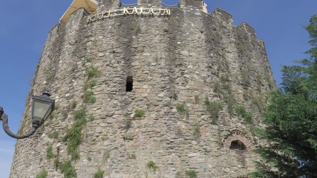 Tilt-up view of the ancient stone tower of Elbasan Castle, a prominent historical landmark in Albania.