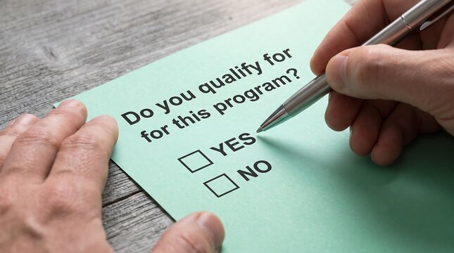 Person completing a program eligibility form with yes or no checkboxes
