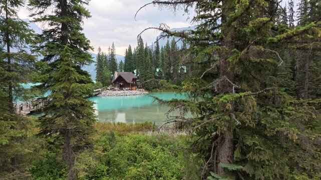 Summer travel at Lake Emerald reflecting in Yoho National Park, British Columbia, Canada, with canoes by lake and mountains by aerial view. Tourism, vacation, outdoor recreation and adventure