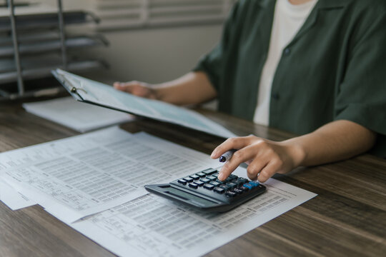 The concept of tax return preparation and financial management. Businessman calculates taxes. finance, Income tax, tax documents, and savings.