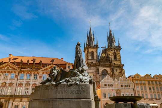 Prague, Czechia - 08 May 2023: View of the Jan Hus Memorial in the Old Town Square with the Church of Our Lady before Tyn in the background under a clear blue sky.