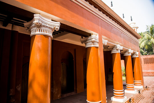 Dhaka, Bangladesh - 21 January 2022: View of the historic Lalbagh Fort mosque with its distinctive orange walls and classical columns in Dhaka, Bangladesh.