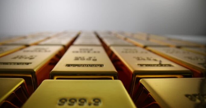 Gold bars with stamped weight and fineness marks on light background. Large asset on golden precious metal ingots as financial reserve in bank