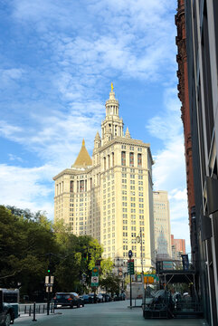 New York, New York, United States - 10 September 2026: View of Manhattan Municipal Building with its golden roof and ornate tower under a blue sky in New York City.