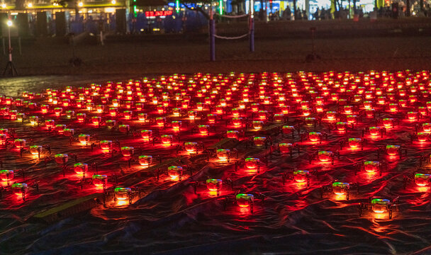 Busan, South Korea - 14 February 2026: View of a large grid of glowing red lights arranged on the ground at night, creating a vibrant display.
