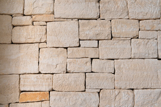Traditional limestone wall featuring rough blocks and natural stone texture