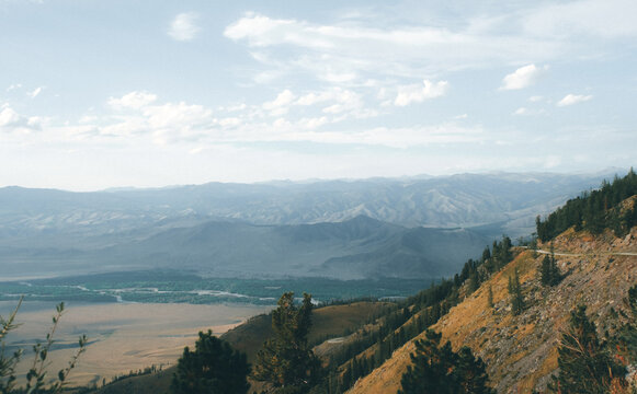 Vast mountain valley spreading under soft overcast sky in Katon Karagay