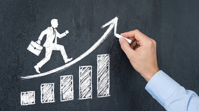 White chalk drawing of a man running up a bar graph towards an upward trending arrow on a black chalkboard, symbolizing growth and progress.