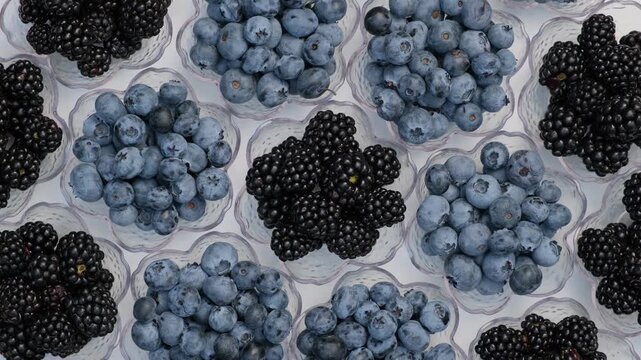 Fresh Blueberries and Blackberries Rotating in Small Bowls Top View Flat Lay Concept of Healthy Eating and Fresh Berries