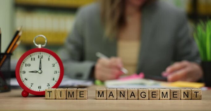 Businesswoman writes detailed list of important tasks in pad against phrase Time Management. Woman organizes busy schedule and plans valuable time