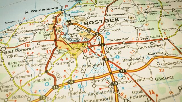 gliding view over a detailed road atlas map toward rostock, germany