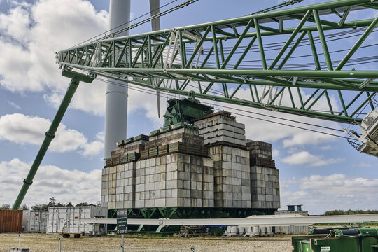 Thisted, Denmark - 11 August 2026: View of the massive 3000-ton counterweight of the electric ring crane at the National Test Center for Large Wind Turbines in Osterild under a cloudy sky.