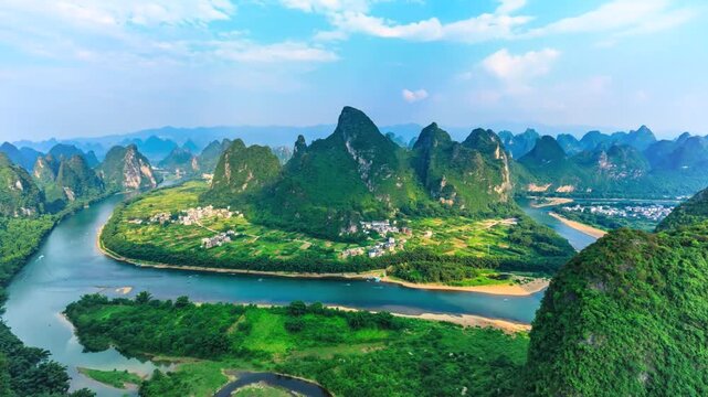 Aerial drone footage of meandering river winding through lush karst mountains in guilin china