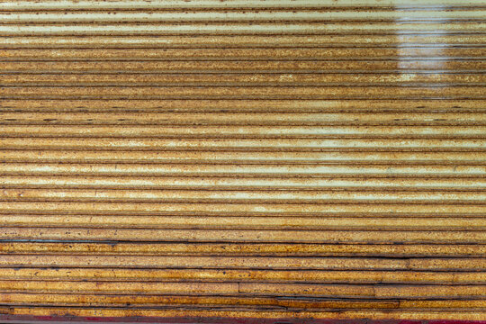 Rusty industrial metal shutter with horizontal lines