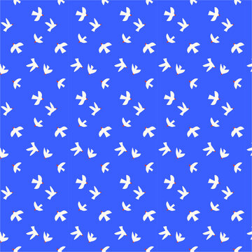White paper birds flying against a vibrant blue sky during daylight with red accents symbolizing freedom and peace