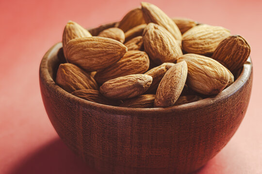 Almonds in a wooden bowl provide a crunchy snack, a healthy treat, or an appetizer, offering a delicious combination of energy and flavor.