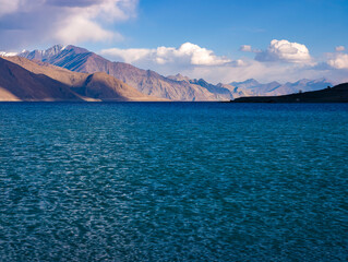 Vivid blue waters of Pangong Lake in Ladakh, India, with rugged mountains and a clear blue sky in the background, creating a striking high-altitude landscape. September 2026. © NICK