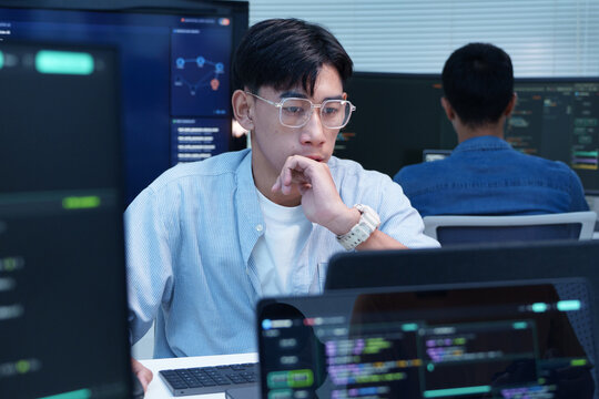 Thoughtful Programmer Analyzing Digital Code