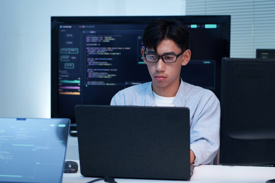 Programmer Working on Software Code with Laptop