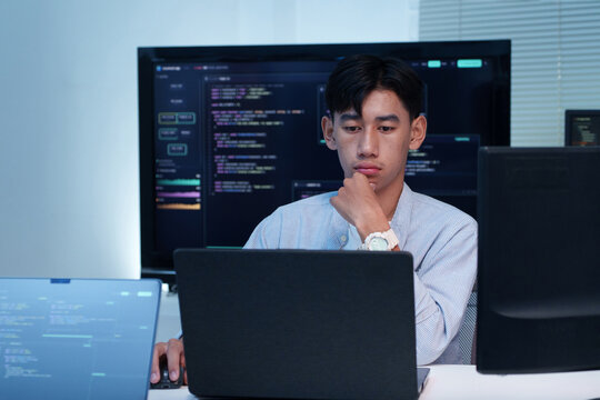 Thoughtful Programmer Working on Digital Code Development