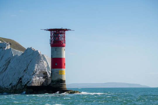 Alum Bay, United Kingdom - 05 September 2026: View of The Needles Lighthouse standing against white chalk cliffs and the blue sea.