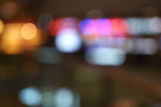 Blurred night scene with various colorful lights and indistinct shapes