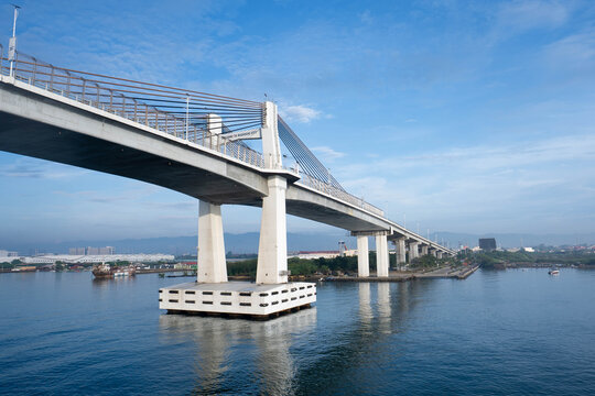 View of the Marcelo B. Fernan bridge spanning the water with concrete pylons and cable-stayed architecture under a clear blue sky in Cebu City, Central Visayas, Philippines.