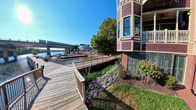 Camera glide explores marina boardwalk and surrounding scenery in Occoquan Virginia during daytime.
