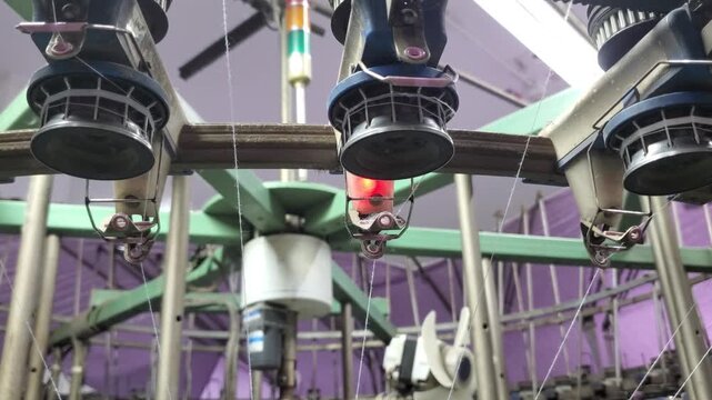Yarn Break Alarm With Red Warning Light On Circular Knitting Machine
Circular knitting machine showing red warning light alarm after yarn breakage. The automatic yarn break detector stops the industri